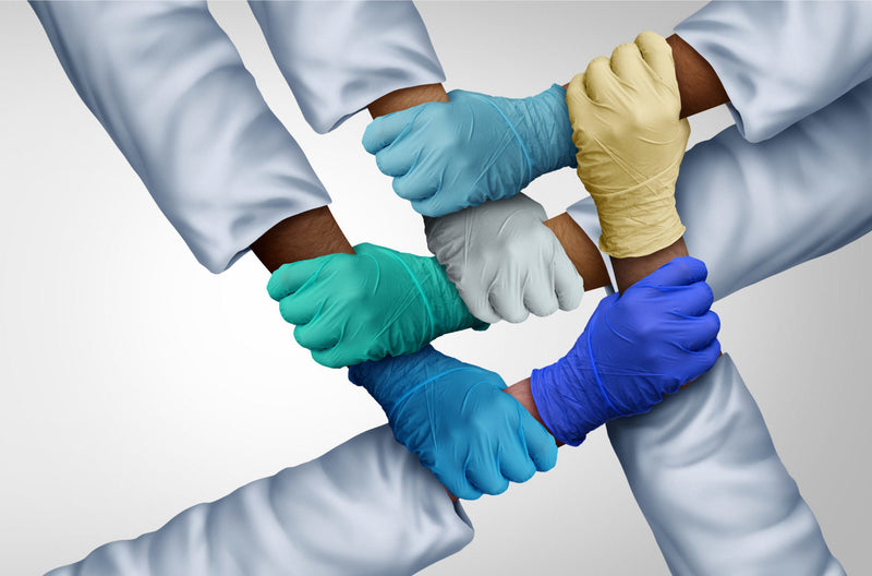 Doctors holding gloved hands